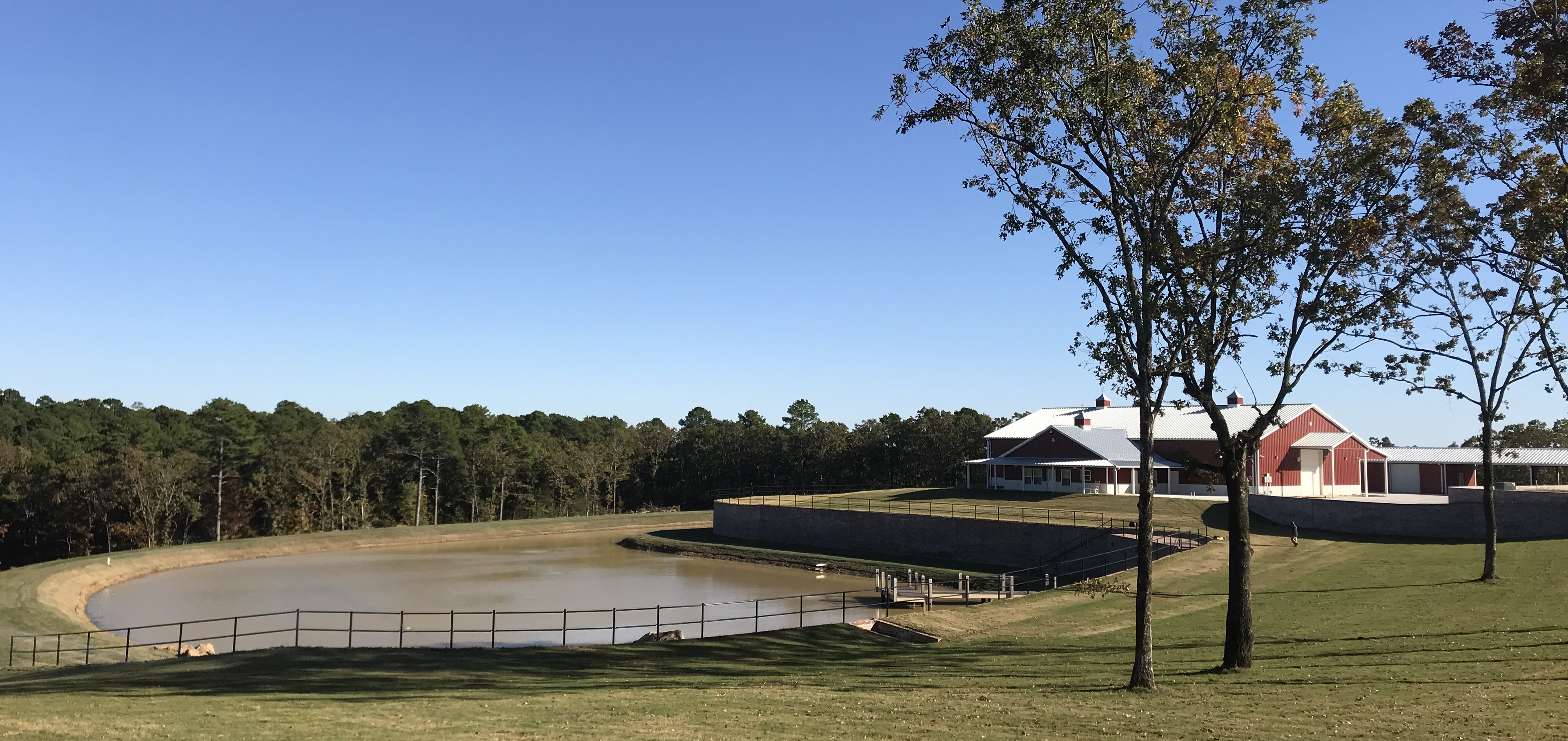Arkansas Office and Warehouse — Piraino Consulting property with pond and barn buildings